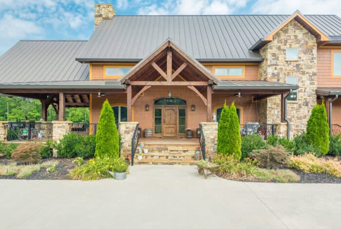 Custom log home with stone accents in a scenic mountain setting, showcasing natural materials and cr.
