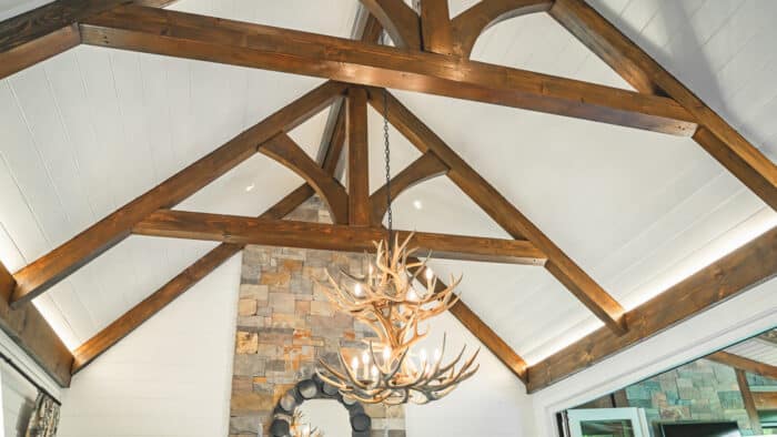 Elegant hybrid timber frame home with natural materials set in a scenic mountain landscape, showcasi.