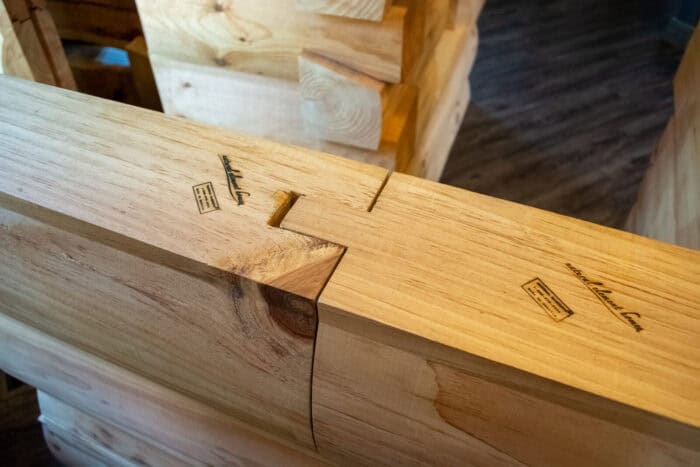 Handcrafted natural wood walls for custom log cabin or timber frame home in scenic mountain or lakes.