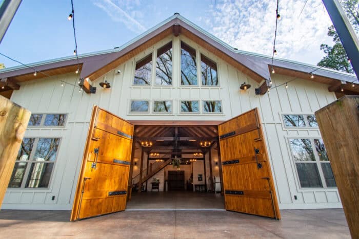 Elegant mountain-style hybrid home with natural materials and large wooden doors, perfect for a cust.