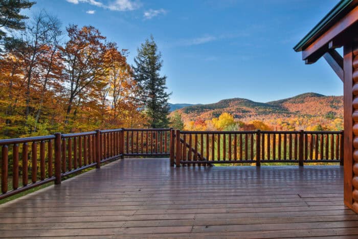 Custom log home deck with mountain views, natural materials, and rustic craftsmanship.