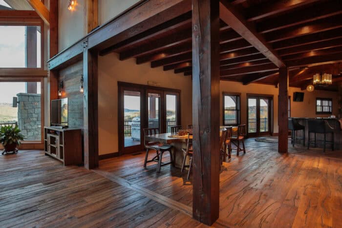Rustic log cabin interior with natural wood finishes, mountain views, and open living space, showcas.