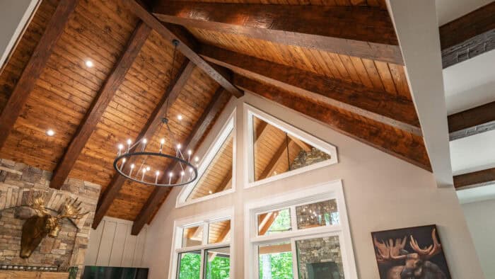 Custom log cabin interior with timber frame accents in a scenic mountain setting.