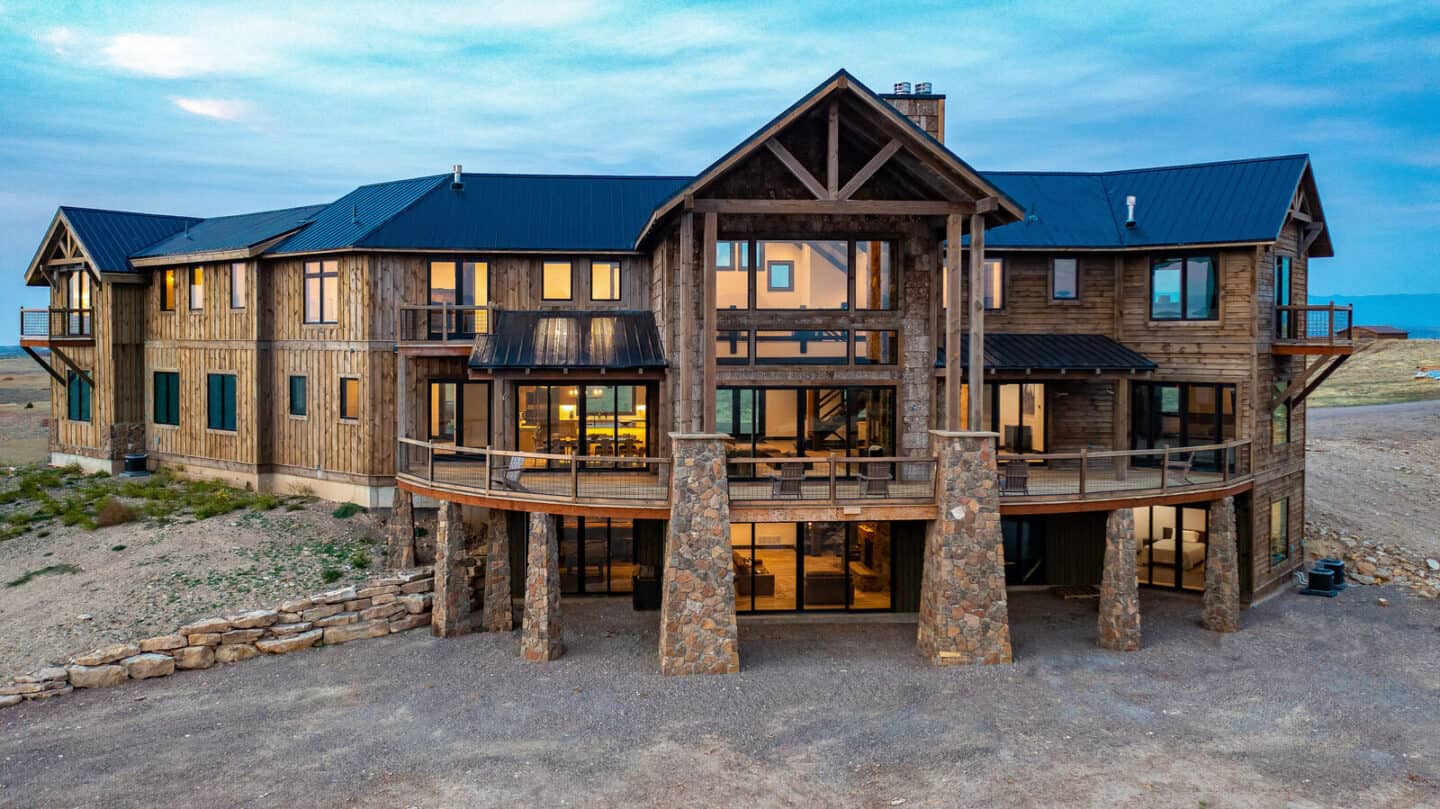 Custom mountain log cabin with natural materials and timber frame architecture by Natural Element Ho.