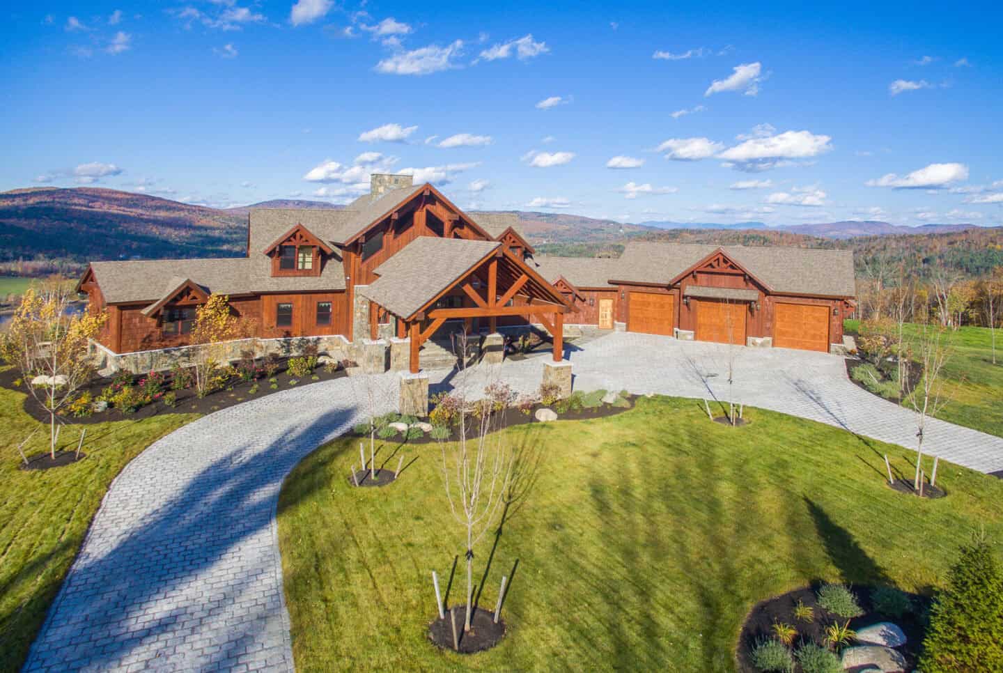 Elegant log cabin home with natural materials set in a scenic mountain landscape, showcasing custom.