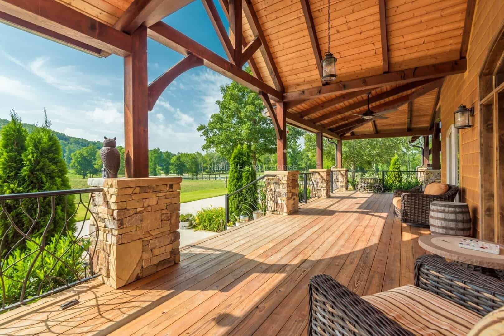 Custom log cabin porch with natural materials in mountain setting, rustic architectural style.