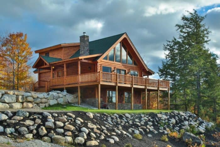 Rustic log cabin home with mountain views, natural materials, and a spacious deck, showcasing custom.