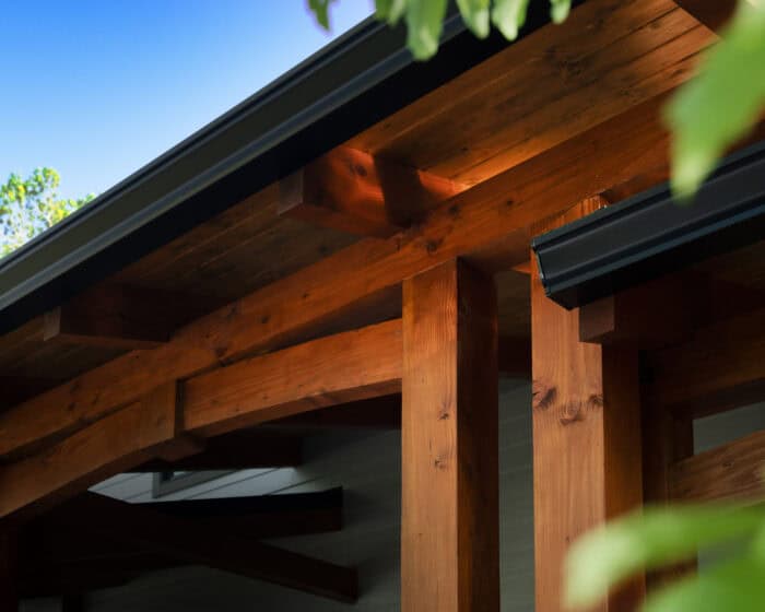 Custom natural log cabin with timber frame architecture in scenic mountain setting.
