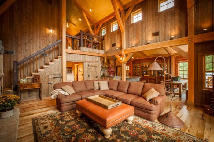 Custom log cabin home with timber frame architecture in a scenic mountain setting, crafted from natu.