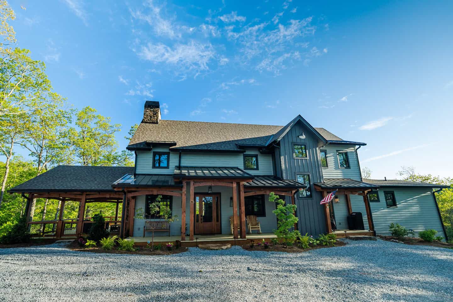 Custom mountain log home with natural materials and timber frame design in scenic outdoor setting.