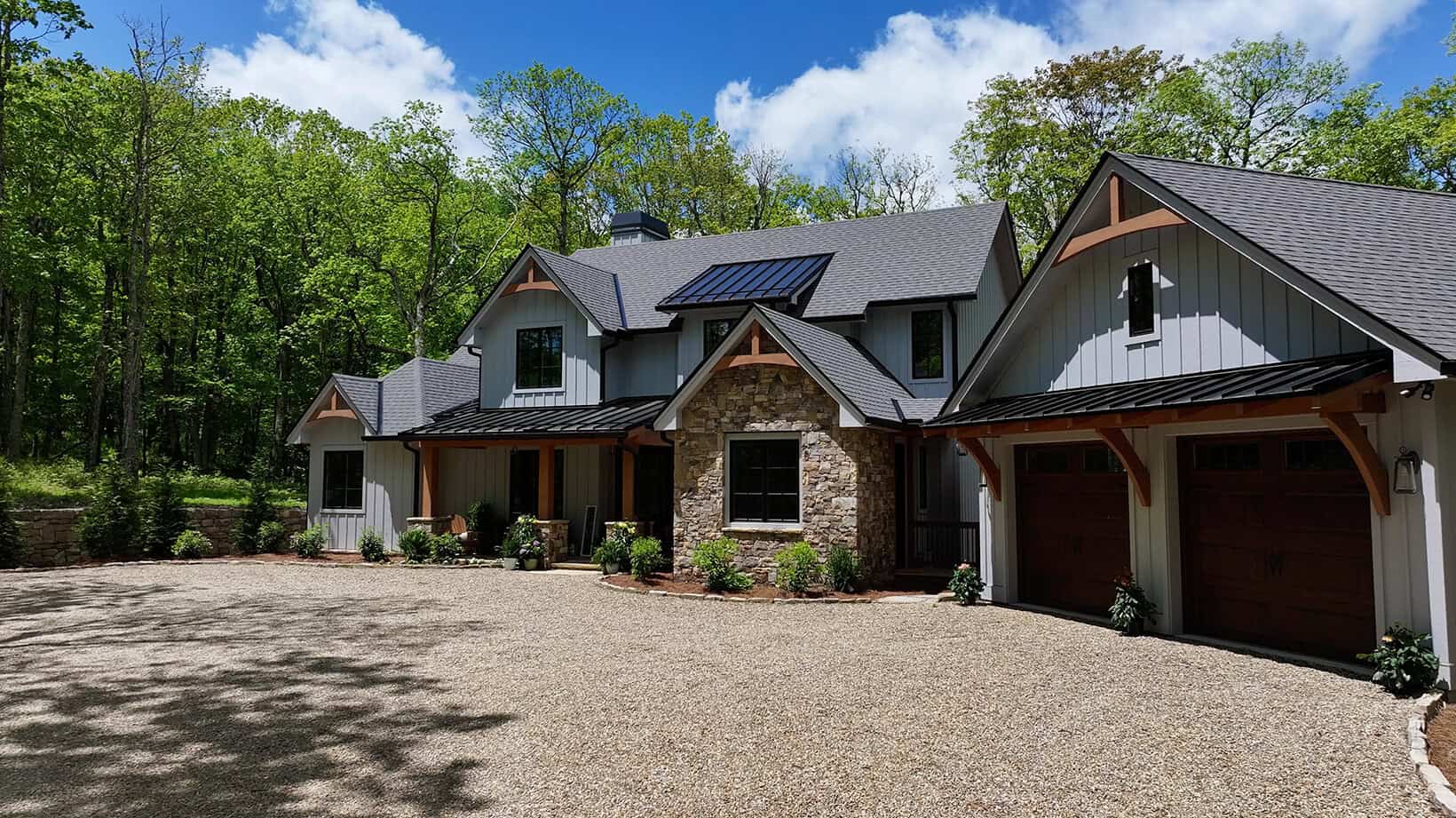 Elegant mountain retreat featuring a custom hybrid home with natural stone and timber frame elements.