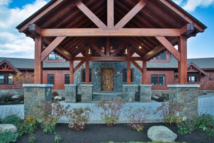 Rustic log cabin with timber frame accents, set in a scenic mountain landscape, showcasing natural m.