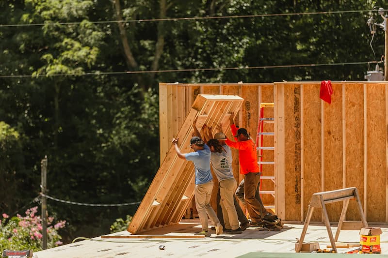 Custom log home under construction — Natural Element Homes build team